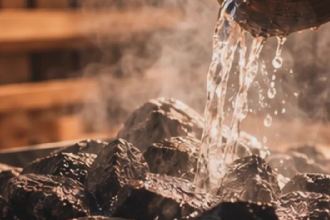 Water poured over hot sauna stones, rising as steam